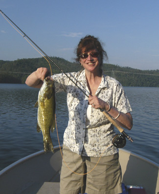 Paula with smallmouuth bass she caught on a Knucklehead.